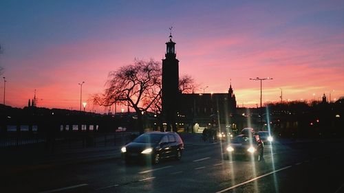 Traffic on road at sunset