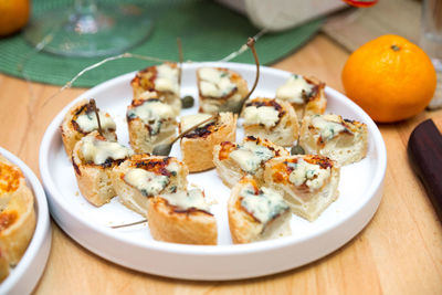 A plate of sliced tartlets with gorgonzola edible moldy cheese. bite size portions.