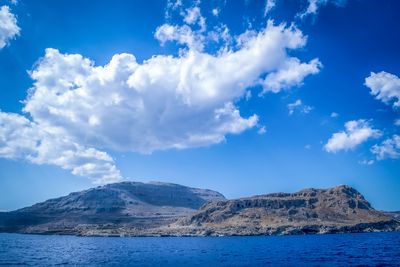 Scenic view of mountains against cloudy sky