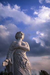 Low angle view of statue against cloudy sky