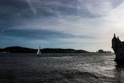 Sailboats in sea against sky