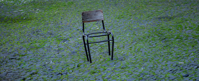 High angle view of empty chairs and table on field