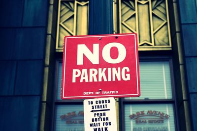 Low angle view of no parking sign outside building