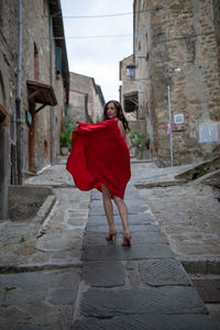 Full length portrait of woman with red umbrella