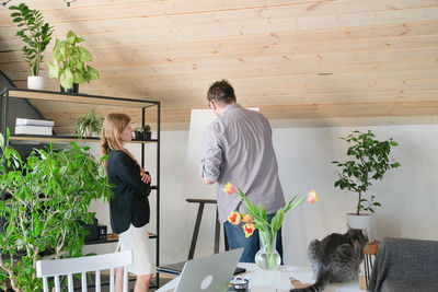 Side view of woman sitting on table