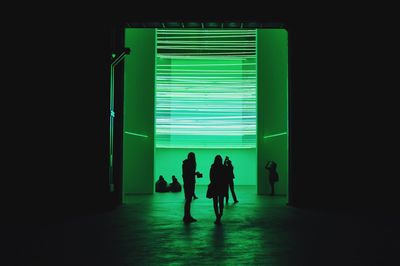 People in illuminated room