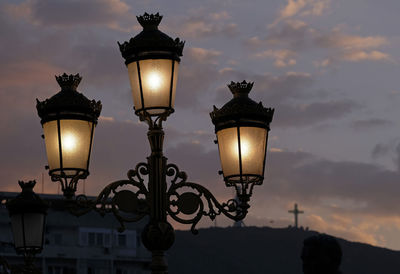 Streetlights in skopje, north macedonia, against a dramatic evening sky