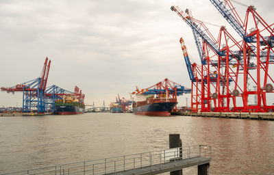 Commercial dock by pier against sky