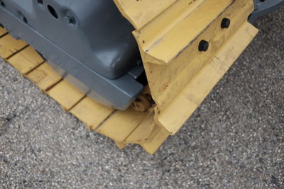 Close-up of yellow car on street