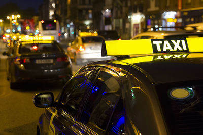 Cars on city street at night