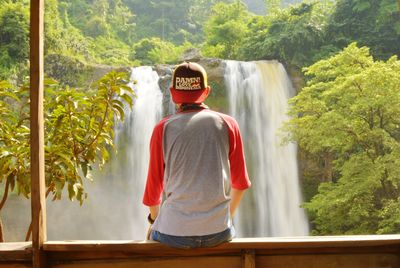 View of man looking at sodong waterfall in forest