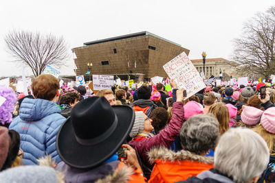 People at town square against sky in city