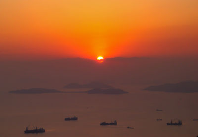 Scenic view of sea against orange sky