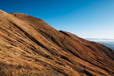 Scenic view of rocky mountains against clear sky in amatrice, lazio italy 
