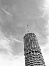 Low angle view of modern building against cloudy sky