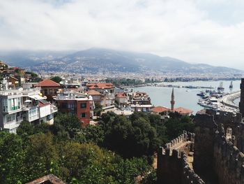 High angle view of townscape and bay against sky