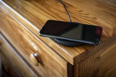 Smartphone charging on wireless charging base.