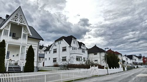 Buildings against cloudy sky