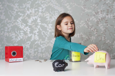 Portrait of girl with toy on table