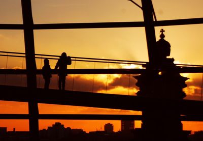 Low angle view of silhouette people at sunset