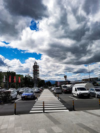 Cars on road in city against sky