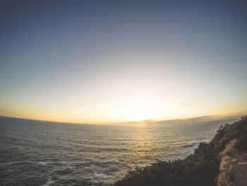 Scenic view of sea against clear sky during sunset