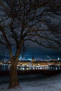 View of river and illuminated buildings at night