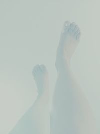 Low section of woman standing on tiled floor