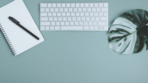 High angle view of laptop and text on table against white background