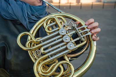 Midsection of man playing musical instrument