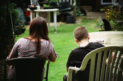 Rear view of woman with son sitting at outdoor restaurant