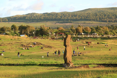 People waiting for sunset view at ahu tahai on easter island, chile