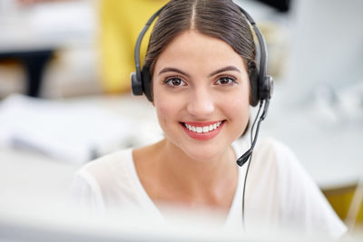 Portrait of smiling businesswoman wearing headset
