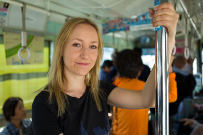 Close-up of young woman in train