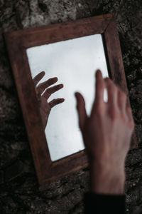 Close-up of hand reflecting in mirror