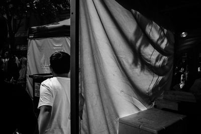 Rear view of man at market stall in chinatown