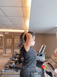 Full length of young woman standing in gym