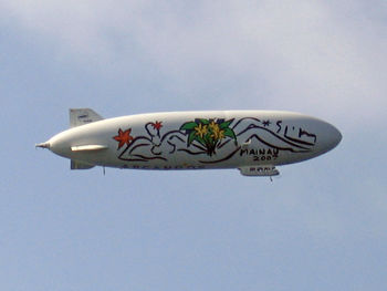 Low angle view of airplane flying against sky