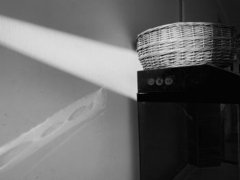 Close-up of electric lamp on table against wall