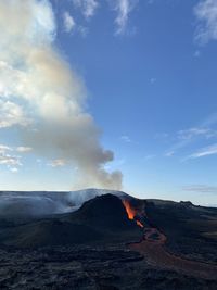 Smoke emitting from volcanic mountain against sky