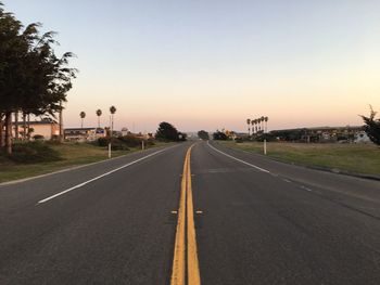 Road against clear sky at sunset