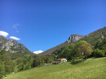 Scenic view of mountains against clear blue sky