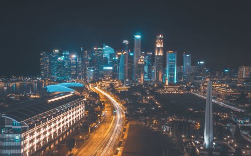 High angle view of illuminated buildings against sky at night