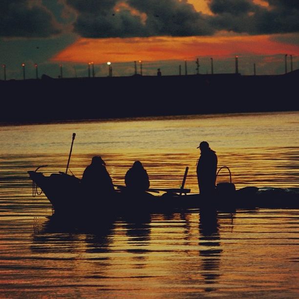 sunset, silhouette, water, sky, orange color, men, lifestyles, cloud - sky, sea, leisure activity, scenics, reflection, beauty in nature, person, togetherness, nautical vessel, boat, nature