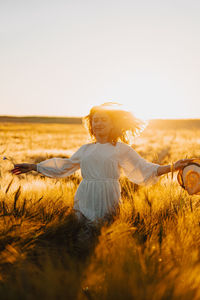 Woman on field against clear sky