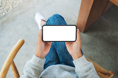 Midsection of woman using mobile phone