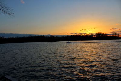 Scenic view of lake against sky during sunset