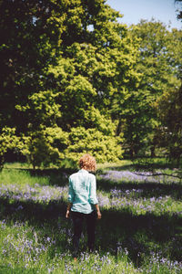 Rear view of young woman walking in lavender field