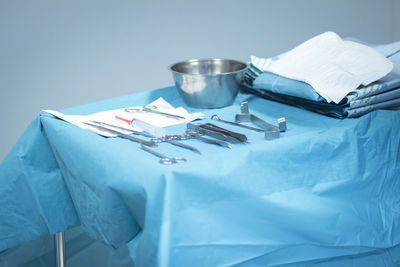 Close-up of objects on table against blue background