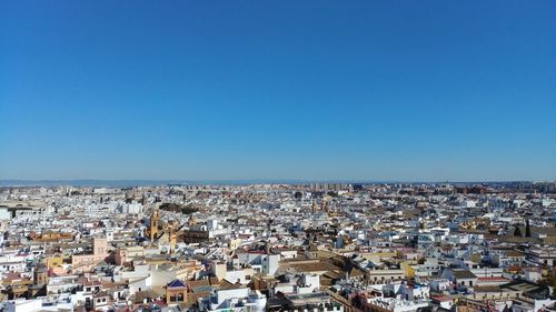 High angle shot of cityscape against clear blue sky